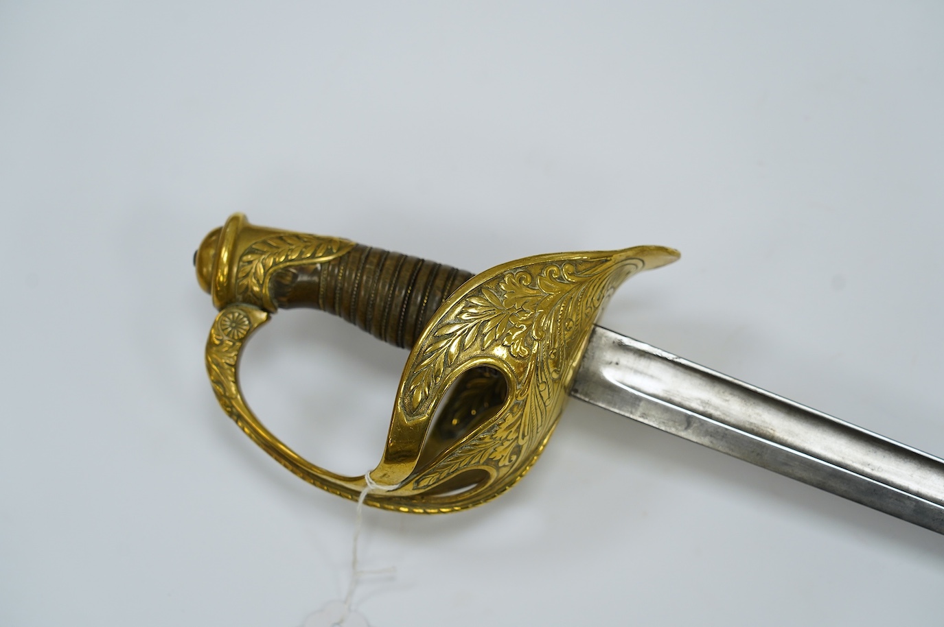 A French 1890 Cuirassier’s sword, brass boat shaped guard with foliage in relief, wirebound horn grip 'Medusa's Head Motif' to thumb scroll, blade 92.5cm. Condition - good